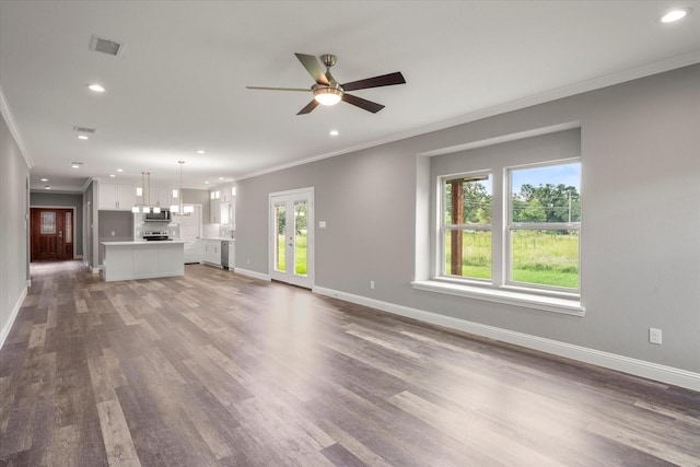 unfurnished living room with dark hardwood / wood-style flooring, crown molding, and ceiling fan