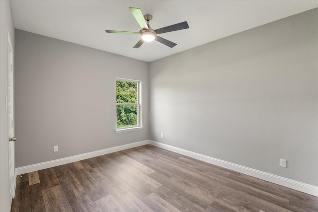 empty room with dark wood-type flooring and ceiling fan