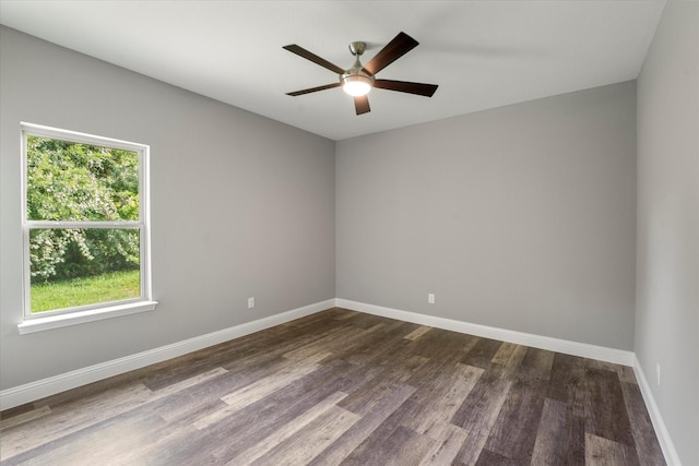empty room featuring dark wood-type flooring and ceiling fan