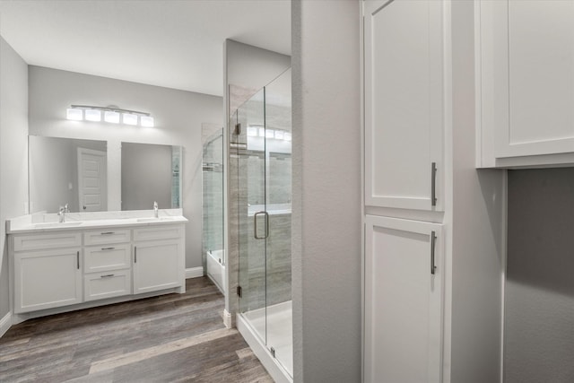 bathroom with a shower with door, wood-type flooring, and vanity