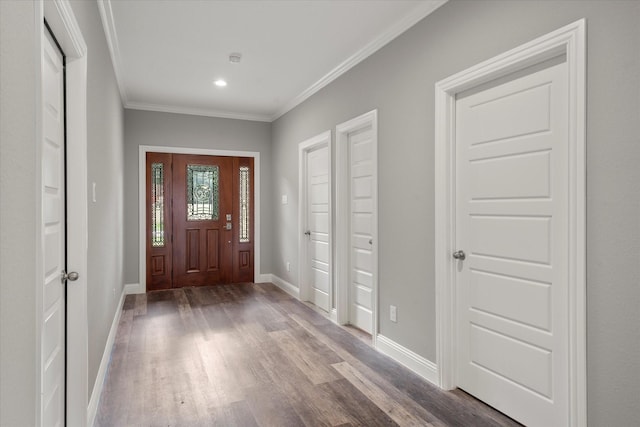 foyer with hardwood / wood-style flooring and crown molding