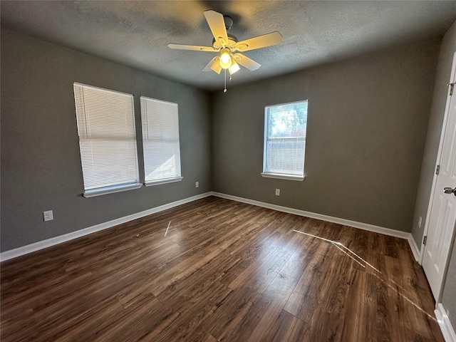 unfurnished room featuring ceiling fan, a textured ceiling, and dark hardwood / wood-style flooring