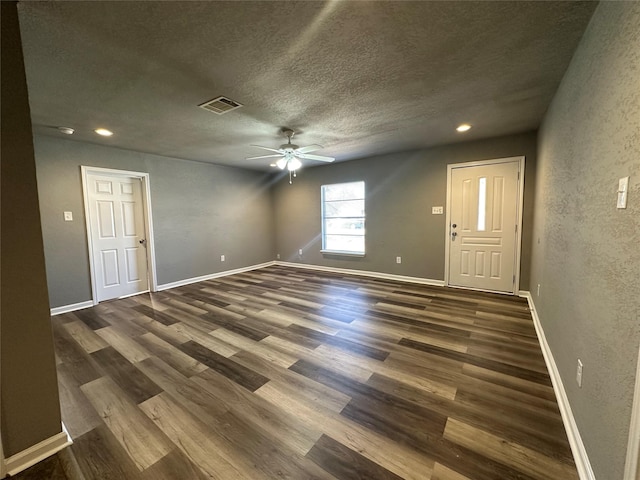 foyer with ceiling fan, dark hardwood / wood-style floors, and a textured ceiling