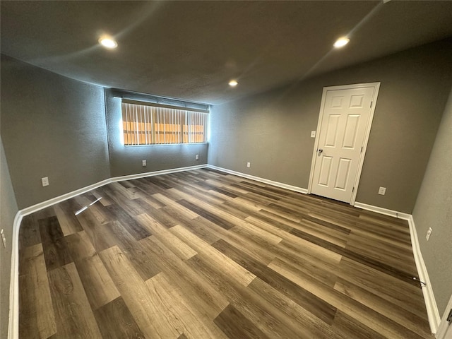 unfurnished room with wood-type flooring