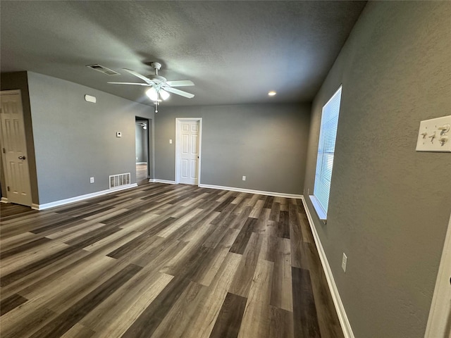 spare room with ceiling fan, dark hardwood / wood-style flooring, and a textured ceiling