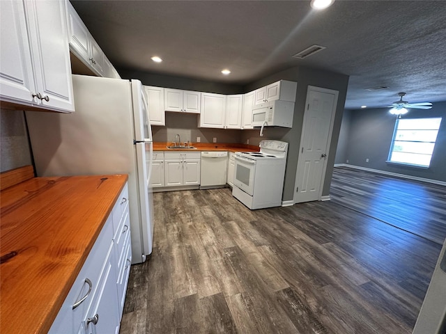 kitchen featuring sink, wooden counters, dark hardwood / wood-style flooring, white appliances, and white cabinets