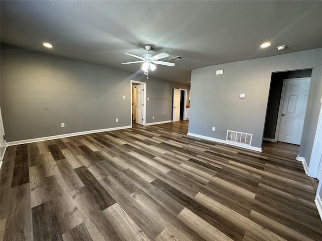 spare room featuring dark wood-type flooring and ceiling fan