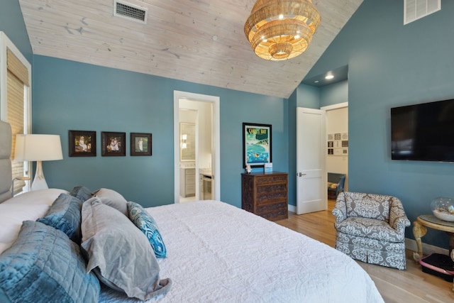 bedroom featuring vaulted ceiling, ensuite bathroom, a notable chandelier, wooden ceiling, and light hardwood / wood-style flooring