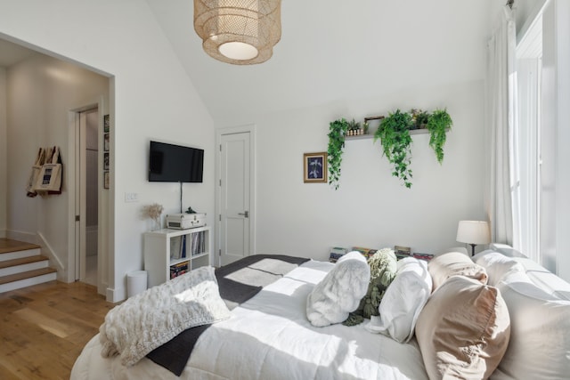 bedroom featuring hardwood / wood-style flooring and vaulted ceiling