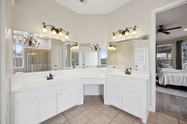 bathroom featuring walk in shower, tile patterned floors, ceiling fan with notable chandelier, and vanity