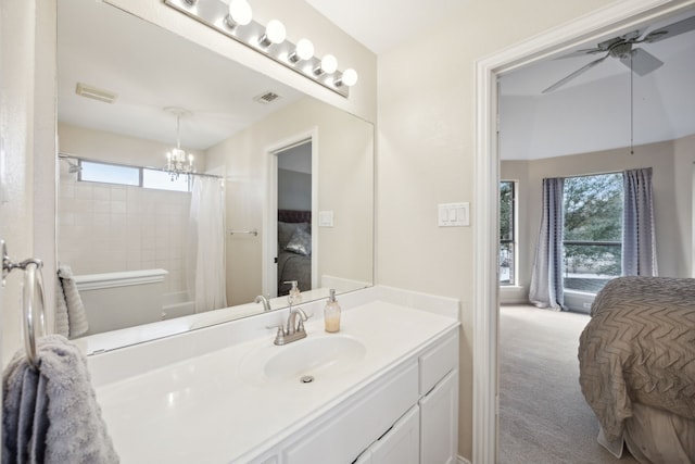 bathroom with vanity, ceiling fan with notable chandelier, and a shower with curtain