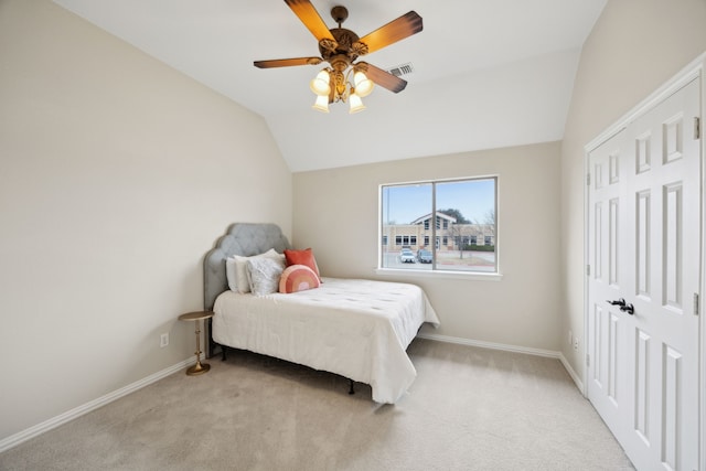 carpeted bedroom with lofted ceiling and ceiling fan