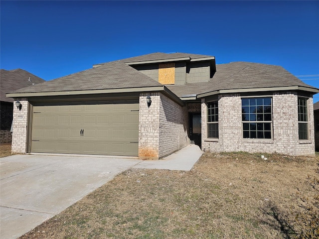 prairie-style home featuring a garage and a front lawn