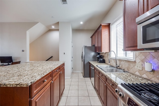 kitchen featuring tasteful backsplash, sink, light tile patterned flooring, and appliances with stainless steel finishes