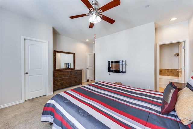 carpeted bedroom featuring ceiling fan and connected bathroom