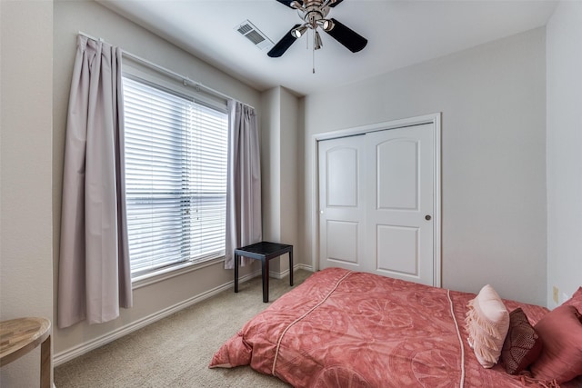 bedroom featuring a closet, ceiling fan, and carpet flooring