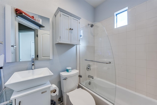 full bathroom with vanity, toilet, and tiled shower / bath