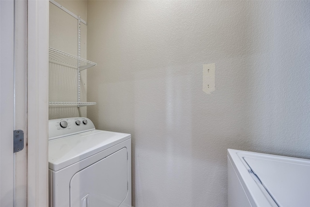 laundry room featuring washing machine and clothes dryer