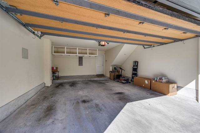 garage with a garage door opener and electric panel