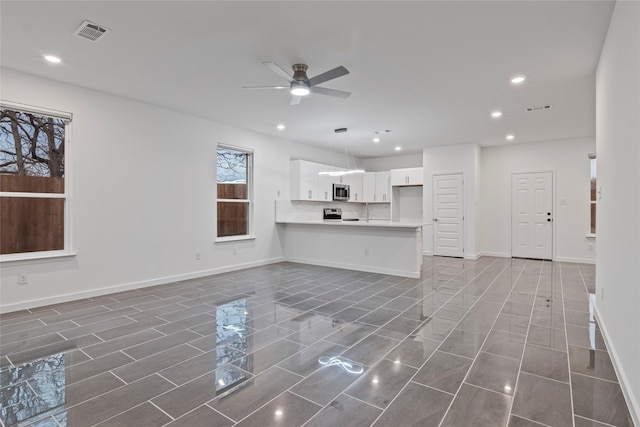 unfurnished living room with ceiling fan