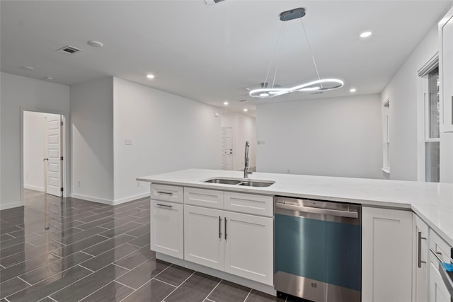 kitchen with white cabinetry, sink, pendant lighting, and stainless steel dishwasher