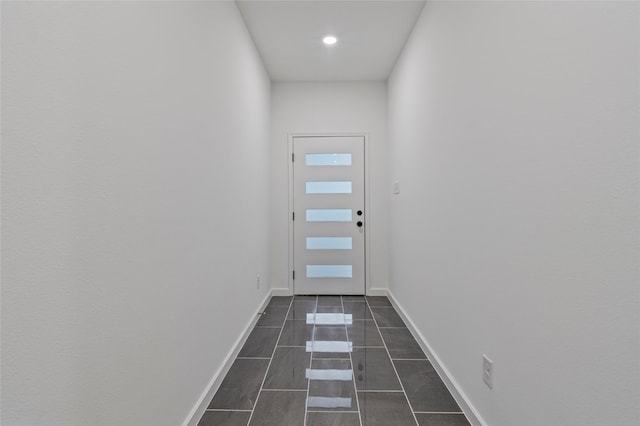 doorway featuring dark tile patterned floors