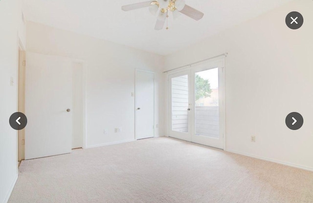 unfurnished room featuring light carpet and ceiling fan