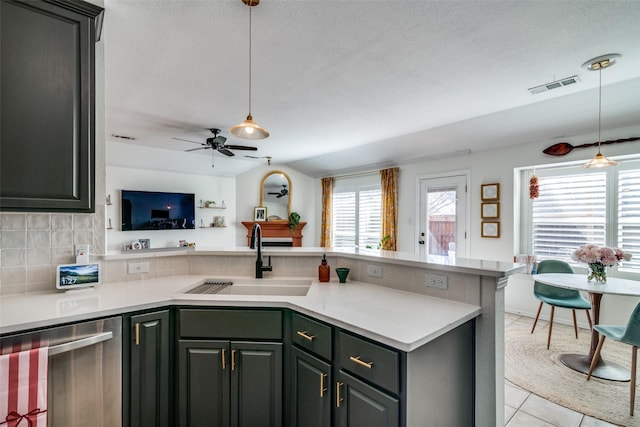 kitchen featuring light tile patterned flooring, sink, dishwasher, pendant lighting, and decorative backsplash