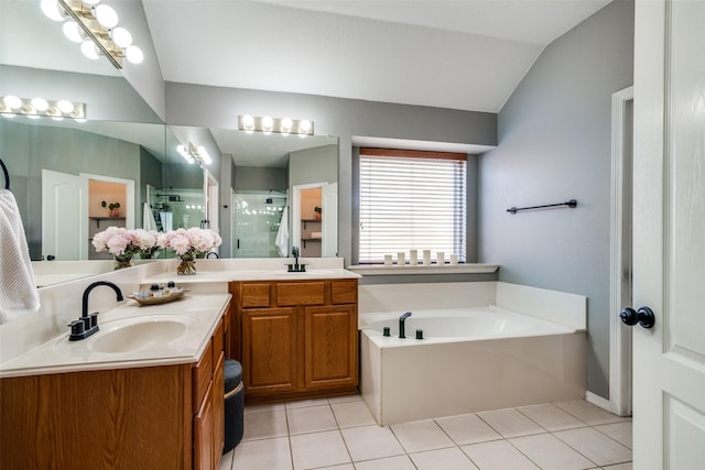 bathroom featuring tile patterned floors, vanity, independent shower and bath, and vaulted ceiling