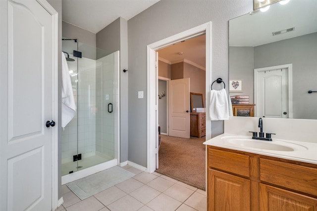 bathroom featuring vanity, tile patterned floors, and a shower with door