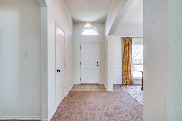 view of carpeted foyer entrance