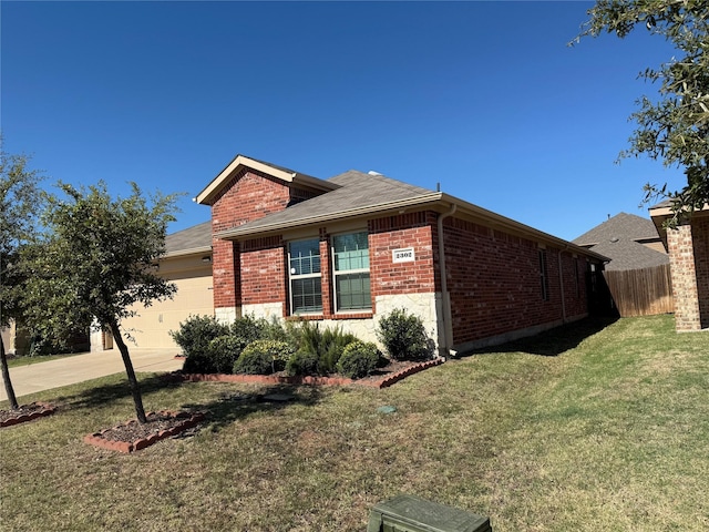 view of side of home featuring a garage and a yard