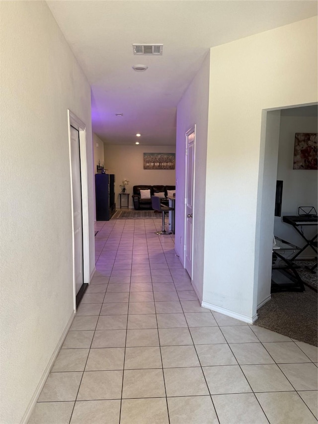 hallway featuring light tile patterned floors