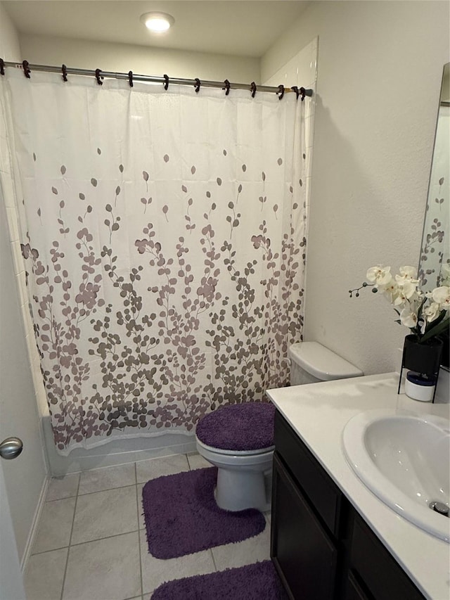 full bathroom featuring tile patterned flooring, vanity, shower / tub combo, and toilet