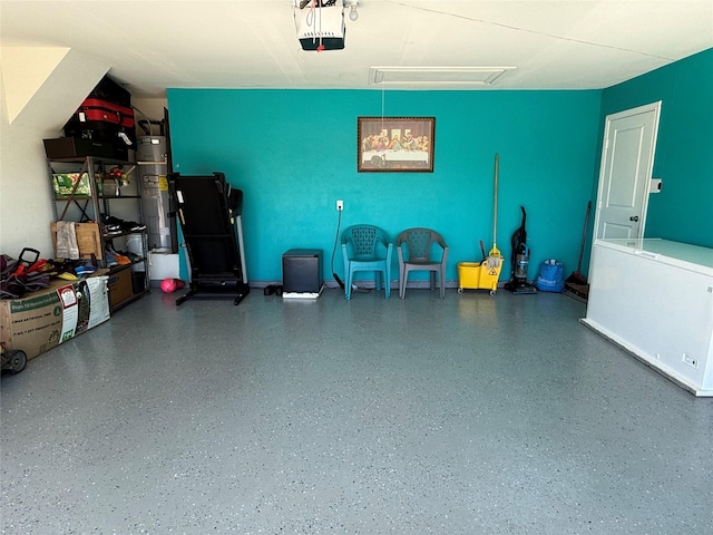 garage featuring fridge, a garage door opener, and water heater