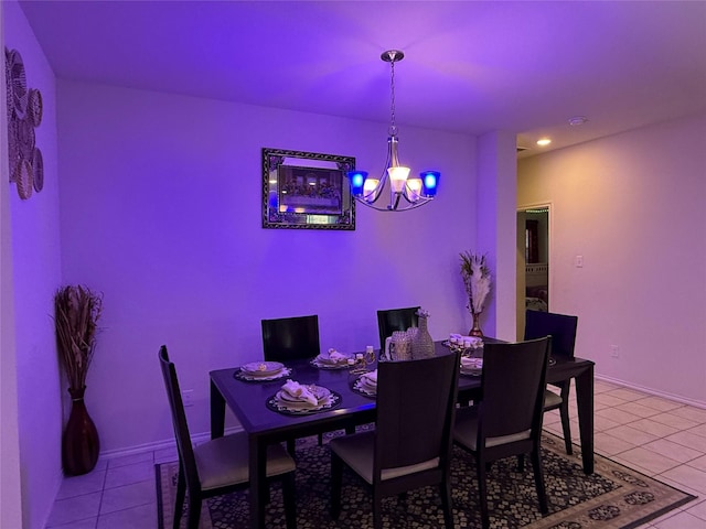 dining room featuring light tile patterned flooring and an inviting chandelier