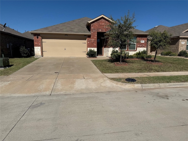 ranch-style home featuring a garage and a front yard