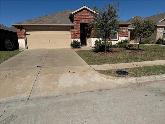 view of front of home with a garage and a front lawn