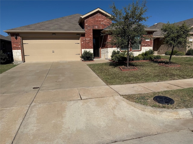 view of front of property with a garage and a front lawn