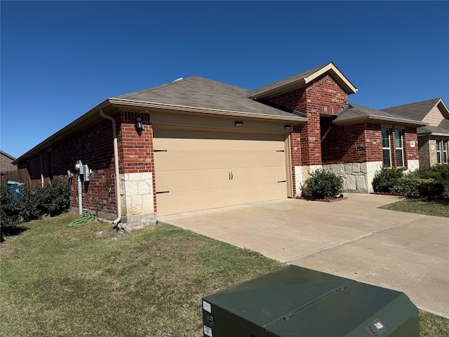 view of side of home featuring a garage and a yard