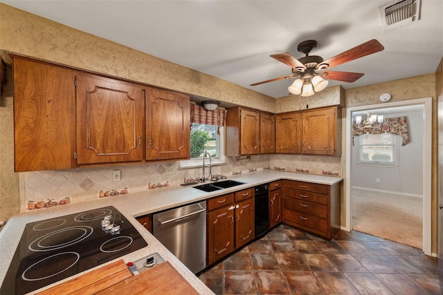 kitchen featuring dishwasher, sink, backsplash, ceiling fan, and cooktop