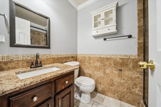 bathroom featuring tile walls, vanity, toilet, crown molding, and tile patterned floors