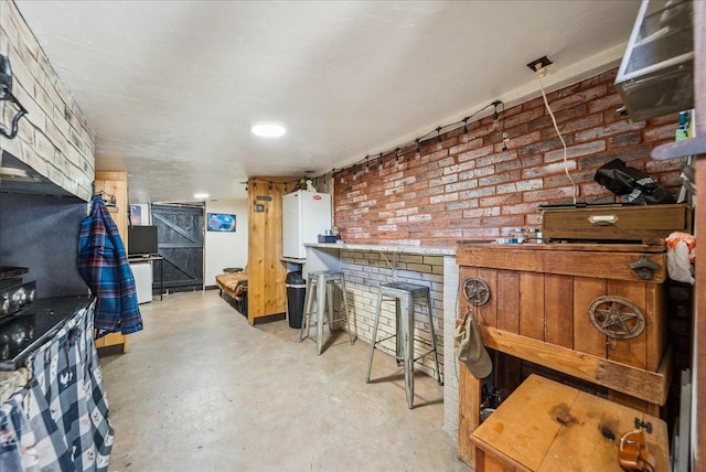 interior space featuring white cabinetry and brick wall