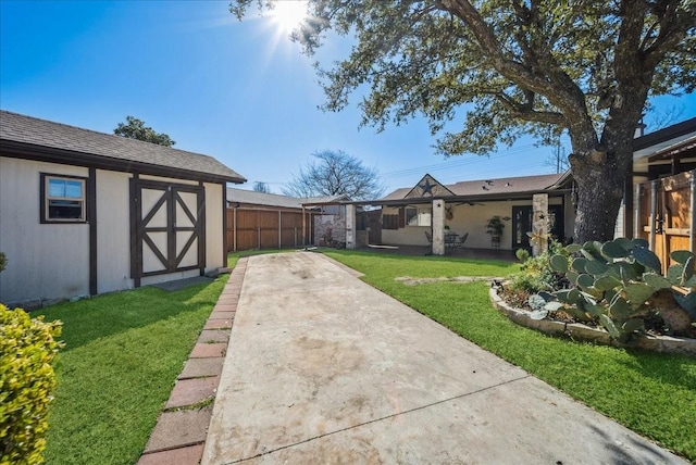 view of yard featuring an outdoor structure and a patio