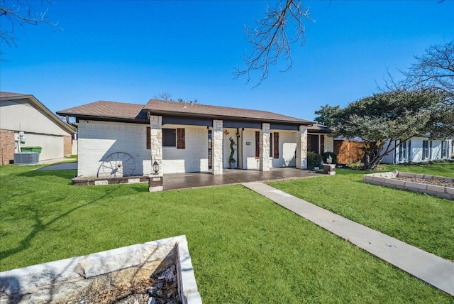 rear view of property with cooling unit and a yard