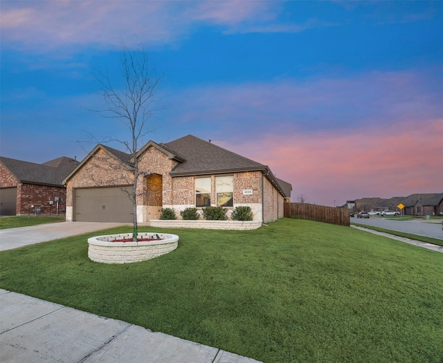 view of front of property featuring brick siding, a shingled roof, concrete driveway, a lawn, and a garage