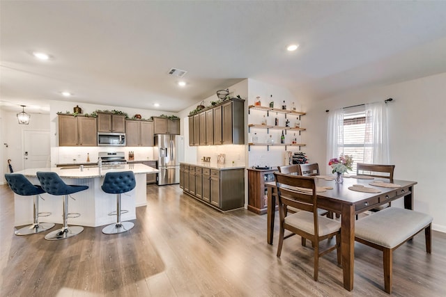 dining space featuring light wood-type flooring, visible vents, and recessed lighting