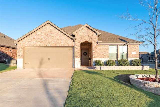 view of front facade with a garage, central AC unit, and a front lawn