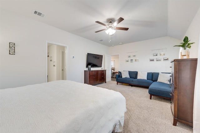 bedroom with visible vents, vaulted ceiling, a ceiling fan, and light colored carpet