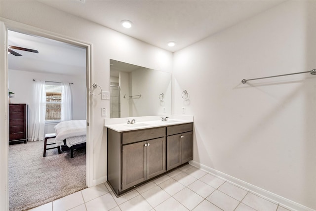 bathroom with a sink, double vanity, tile patterned flooring, and ensuite bath